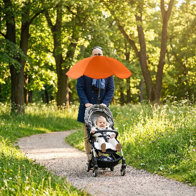 papa promene avec bebe protege par ombrelle pour poussette